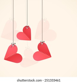 Hanging paper folded red hearts with space for your wishes for Happy Valentine's Day celebration.