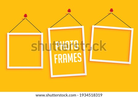 hanging photo frames on yellow background