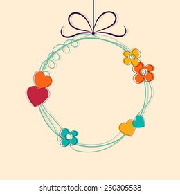 Hanging rounded frame decorated by flowers and hearts with space for your wishes for Happy Valentine's Day celebration.
