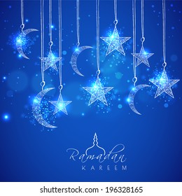 Hanging shiny moons and stars on blue background for holy month of muslim community Ramadan Kareem. 