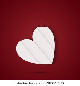 Hanging white paper heart on a red background with gradient