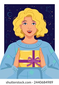 Happily smiling curly blonde girl in blue oversized hand-knit retro sweater holding a yellow giftbox