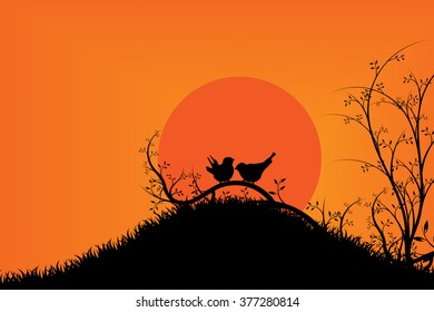 Happiness birds on tree during sunset and orange sky.