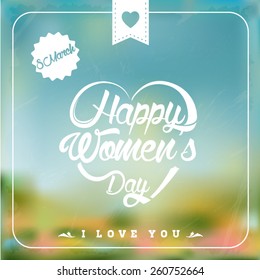 Happpy Womans Day heart shaped typographical background. Blurred background.