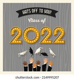 Happy 2022 graduation card design with vintage light bulb sign numbers and graduates throwing hats. Vector illustration.