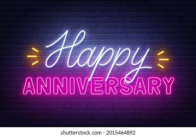 Happy anniversary neon text. Greeting card on brick wall background.