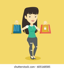 Happy asian woman carrying shopping bags. Smiling woman holding shopping bags. Girl standing with a lot of shopping bags. Girl showing her purchases. Vector flat design illustration. Square layout