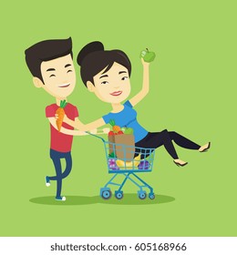 Happy asian woman pushing a shopping trolley with her friend. Couple of young carefree friends having fun while riding by shopping trolley. Vector flat design illustration. Square layout.