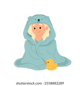 Happy baby girl wrapped in bath towel. Toddler girl with light hair sitting in towel after bath with rubber duck