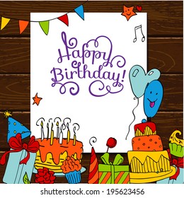 Happy Birthday card background with cakes on wooden table