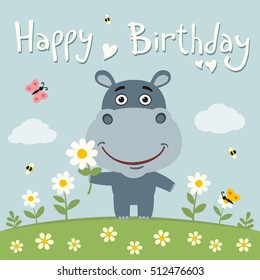 Happy birthday! Cute hippo with flower on meadow. Card in cartoon style. 