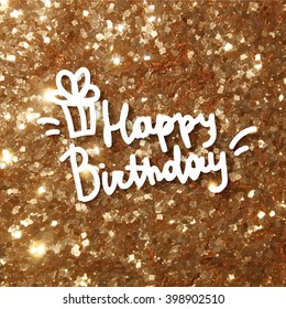 happy birthday, handwritten text and gift box on gold sparkling background