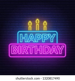 Happy birthday neon sign. Birthday card in the shape of a cake with candles on a dark background.