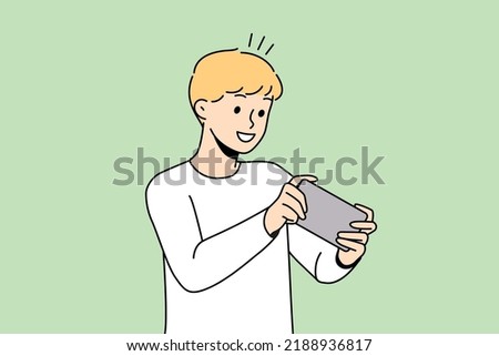 Happy boy child playing online game on cellphone. Smiling small kid have fun engaged in video games on smartphone. Modern web app. Vector illustration. 