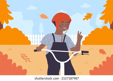 Happy boy cycling in orange autumn park, village landscape vector illustration. Cartoon child character in safety helmet riding bicycle, cheerful kid showing victory or peace hand gesture background