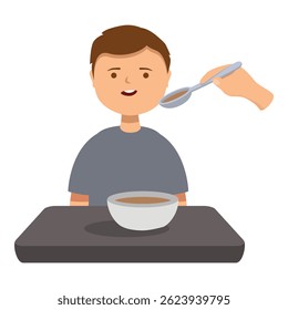 Happy boy eating soup sitting at table being fed by nurse or parent