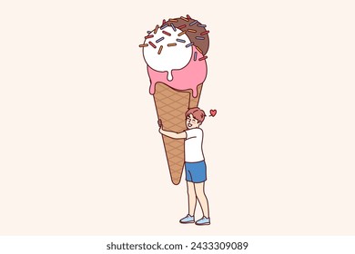 Happy boy with giant size ice cream, waffle cup and colorful sprinkles. Cheerful child hugs sweet ice cream, rejoices at opportunity to try delicious dessert in hot summer weather.
