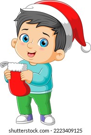 The happy boy is holding and hanging the big sock for the christmas gift of illustration