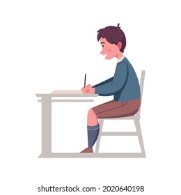 Happy boy with pen sitting at his desk in classroom flat vector illustration