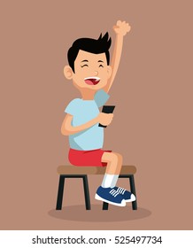 happy boy playing video game sitting on chair