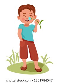 happy boy stands and sniffs a flower, he has a spring mood.