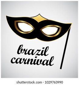 Happy Brazilian Carnival Day. black and golden carnival mask on white background