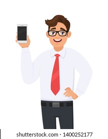 Happy business man showing a new brand, latest smartphone. Young man holding blank screen cell or mobile phone in hand. Modern lifestyle, digital technology device and gadget concept in cartoon style.