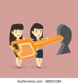 Happy business women standing in front of a keyhole with big key. Business team holding the key to success. Two business women carrying huge golden key. Vector flat design illustration. Square layout.