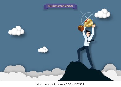 Happy businessman holding a number one trophy on the top of the high mountain. Success, goal, achievement and challenge concept.