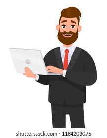Happy businessman holding and using laptop computer standing against isolated white background.  Technology and laptop computer concept illustration in cartoon vector style.