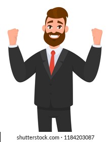 Happy businessman is raising hands in fists and happiness and success. Positive human emotion facial expression. Excited, energetic, happy business man winning, arms up fists celebrating success. 