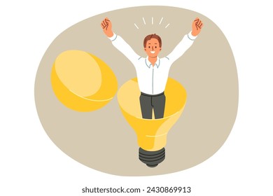 Happy businessman stands inside light bulb, raising hands up and rejoicing at new idea to accelerate professional growth. Man entrepreneur came up with business idea to improve marketing performance