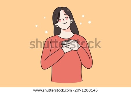 Happy calm young woman hold keep hands at chest feel grateful and thankful at heart. Smiling girl show love, compassion and care. Superstition and faith. Female believer. Vector illustration. 