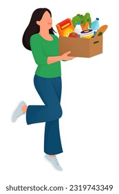 Happy cheerful woman holding a delivery box full of fresh groceries