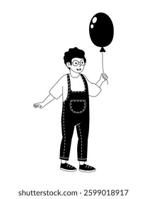 Happy child holding a black balloon while wearing stylish overalls and glasses