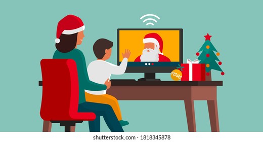 Happy child videocalling Santa with his mother at home, Christmas and social distancing concept