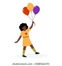 Happy child in a yellow dress holding colorful balloons in a cheerful setting