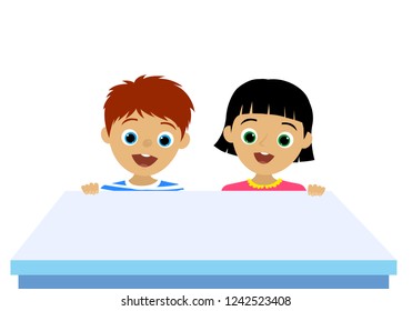 Happy Children Behind The Empty Blue Desk. White Background Isolated. Girl and Boy.