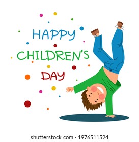 Happy children is a Day. Funny boy stands on one hand.