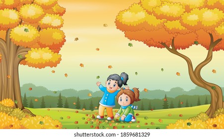 Happy children playing with fallen leaves