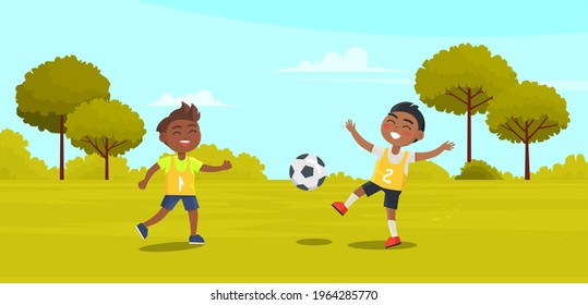 Happy Children Two Boys Black Footballers Playing Soccer In Park On Green Grass. The Best Summer Child's Outdoor Activities. Active Weekend Outdoors Children's Games. Kids Football On Playground