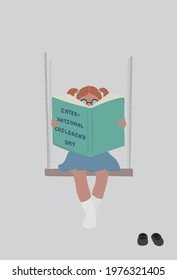 Happy children's day. International children's day. Girl rides on a swing and reads a book. Young girl reads a big book.