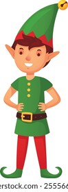 Happy christmas elf wearing a traditional green and red costume, smiling joyfully and posing with hands on hips, exuding festive cheer and ready to celebrate the holiday season