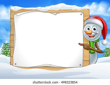 A happy Christmas snowman cartoon character in a winter scene peeking around pointing at a sign