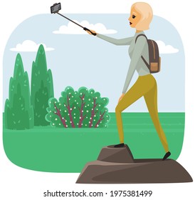 Happy climber reached summit of mountain. Traveling and technology concept. Lady with smartphone is posing for photo on peak. Woman taking selfie on mountain. Girl is photographed while traveling