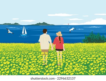 Una pareja feliz mirando al mar desde el campo de la flor de la violación amarilla