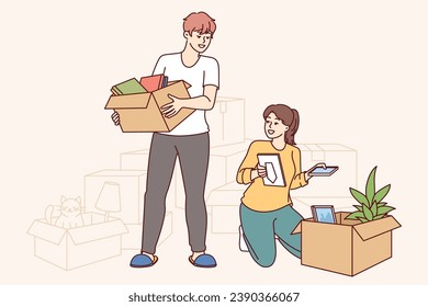 Happy couple moves into new apartment, unpacking boxes personal belongings and rejoicing at improved home conditions. Cheerful guy and girl took out mortgage to buy house and moves to prosperous area