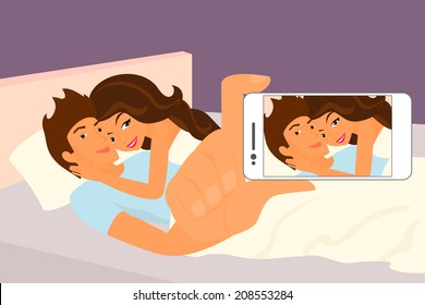 Happy Couple Taking A Snapshot Of Themselves In Bed