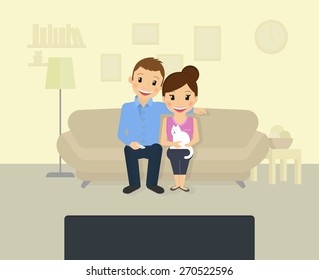 Happy couple is watching tv at home