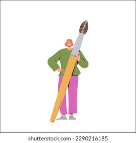 Happy creative woman artist holding giant paintbrush standing isolated on white background